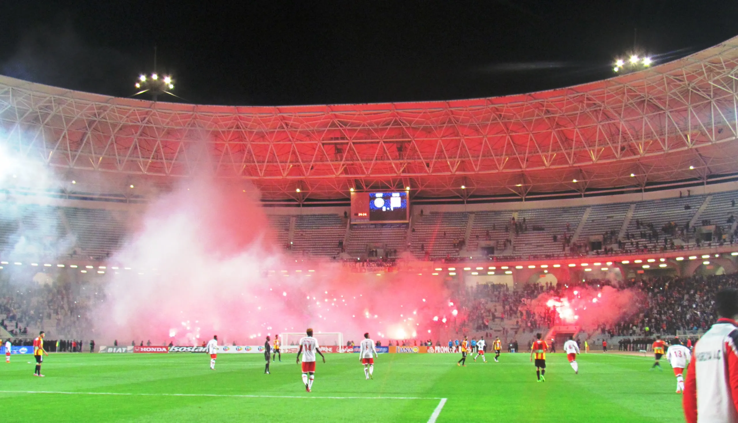 A curva lit with red flares at night